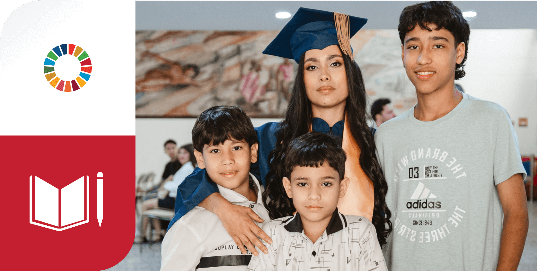 A young graduate in a blue gown and cap poses with her two small children. Her expression is serious yet happy, reflecting the educational achievement that aligns with SDG 4, which promotes inclusive and quality education. To her left, one child smiles at the camera, while the other looks forward with a serious expression. Both are dressed in casual clothing. Behind the graduate, other individuals in gowns and caps can be seen, suggesting that they are at a graduation ceremony. The blurred background shows more people, highlighting the celebration of the moment.